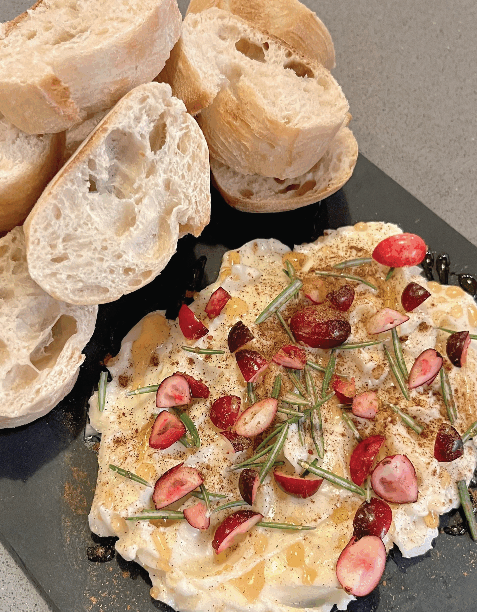 Butter board garnished and next to s side of bread